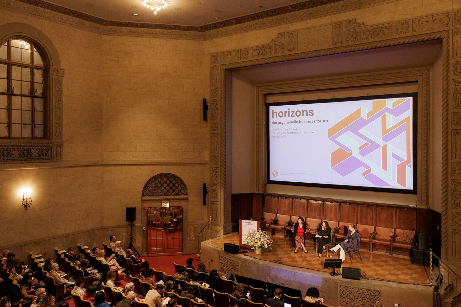 Audience watches panel discussion on stage at the New York Academy of Medicine